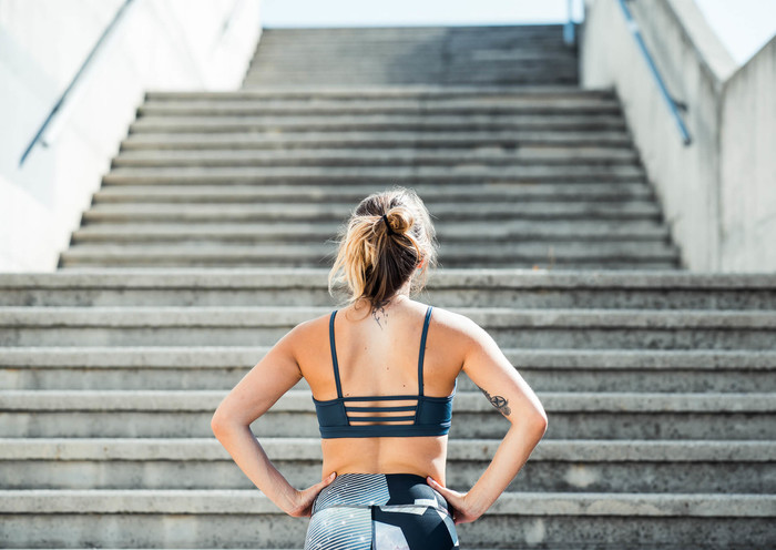 Woman is looking up the stairs
