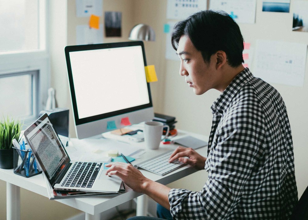 A micro business is the next level side hustle. Man working from home.