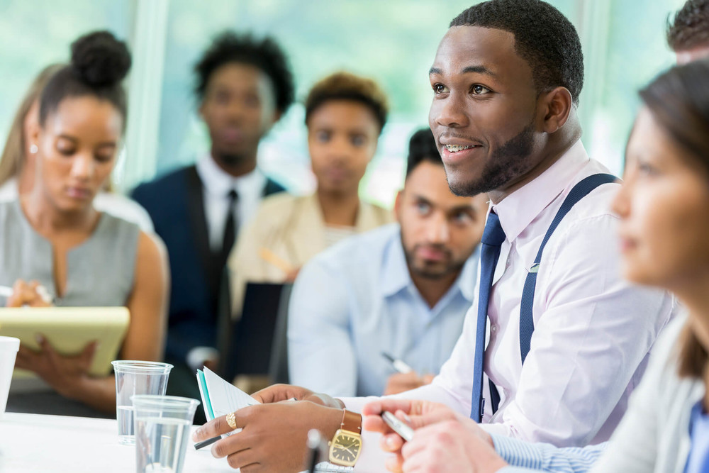 a group of people working on their financial education