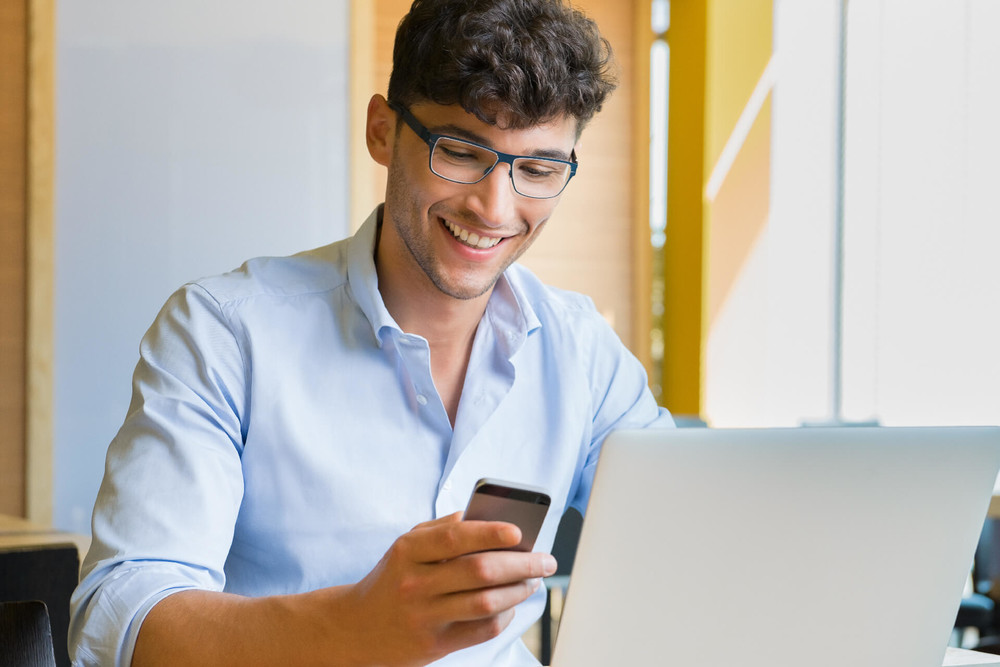 Young man investing from his phone