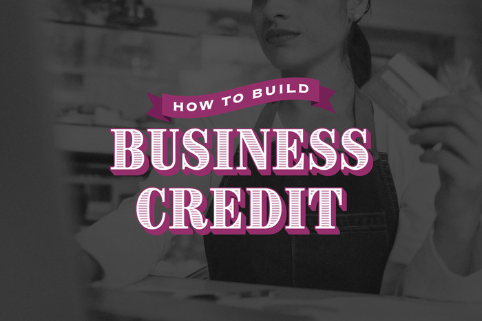 Woman building her business credit by paying with a credit card