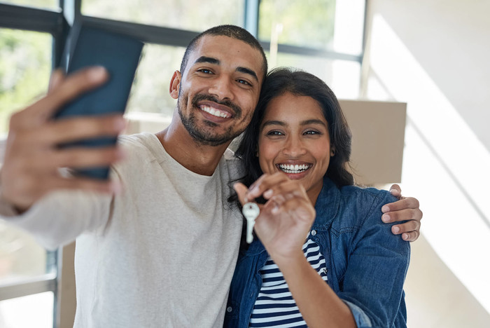 Couple of first time home buyers making a selfie