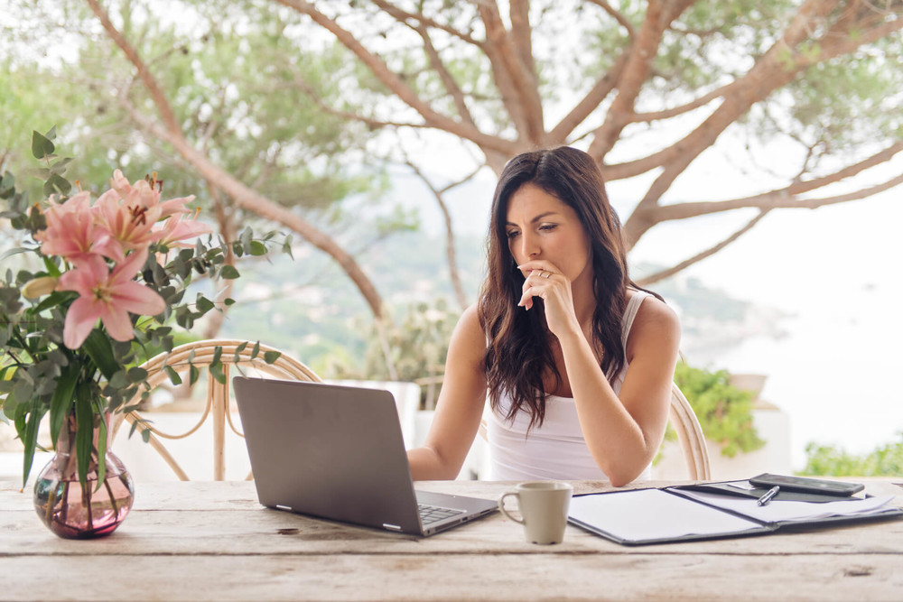 Woman uses laptop to access disability insurance to protect her income