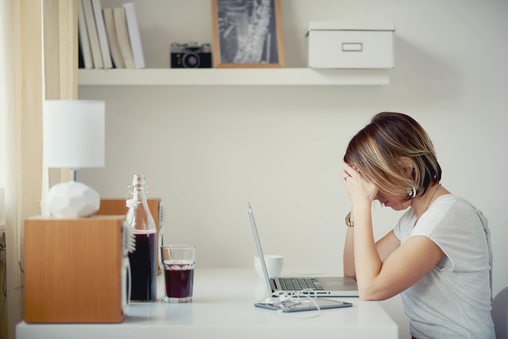 Woman is researching job loss insurance on the computer