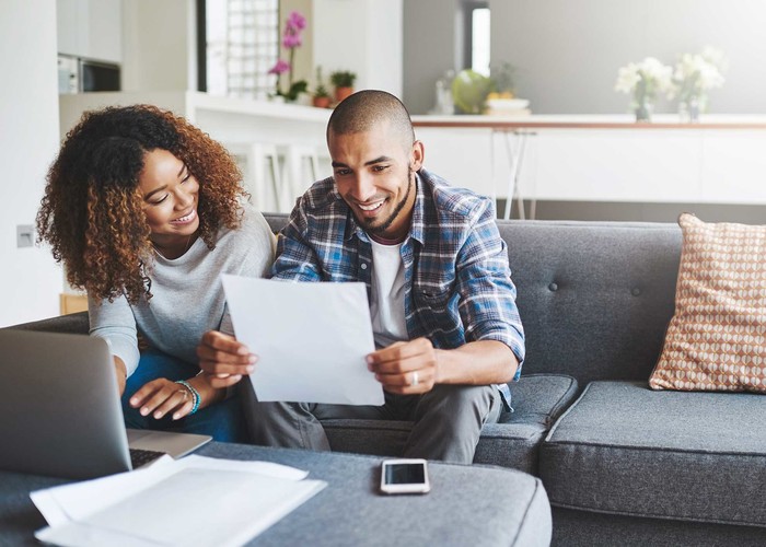 Couple learning budgeting fundamentals and creating their first budget.