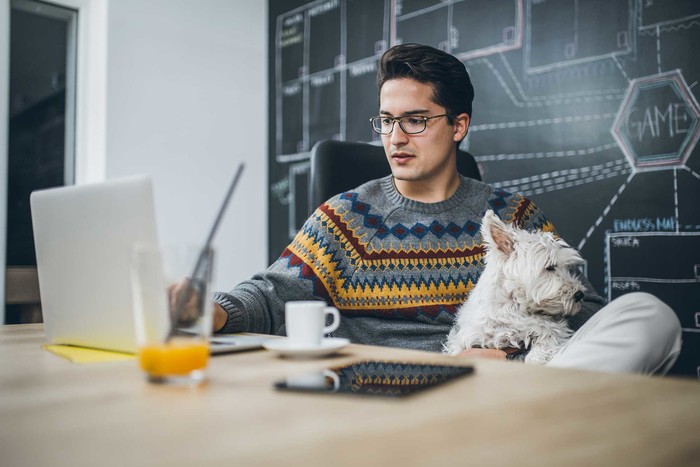 Man is reading about full-time job and side business taxes